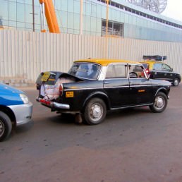 The iconic and venerable Ambassador taxi plies the streets of Mumbai
