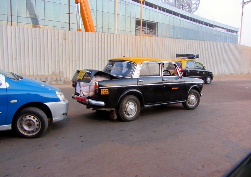 The iconic and venerable Ambassador taxi plies the streets of Mumbai